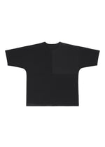 The FLAT T by IM MEN is a plain black oversized jersey T-shirt with wide, straight sleeves and a loose, boxy fit, shown laid flat on a white background.