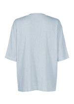 The CREPE TUCK JERSEY by IM MEN, an oversized, short-sleeved T-shirt in light blue made from quick-drying jersey fabric, is shown from the back against a plain white background.