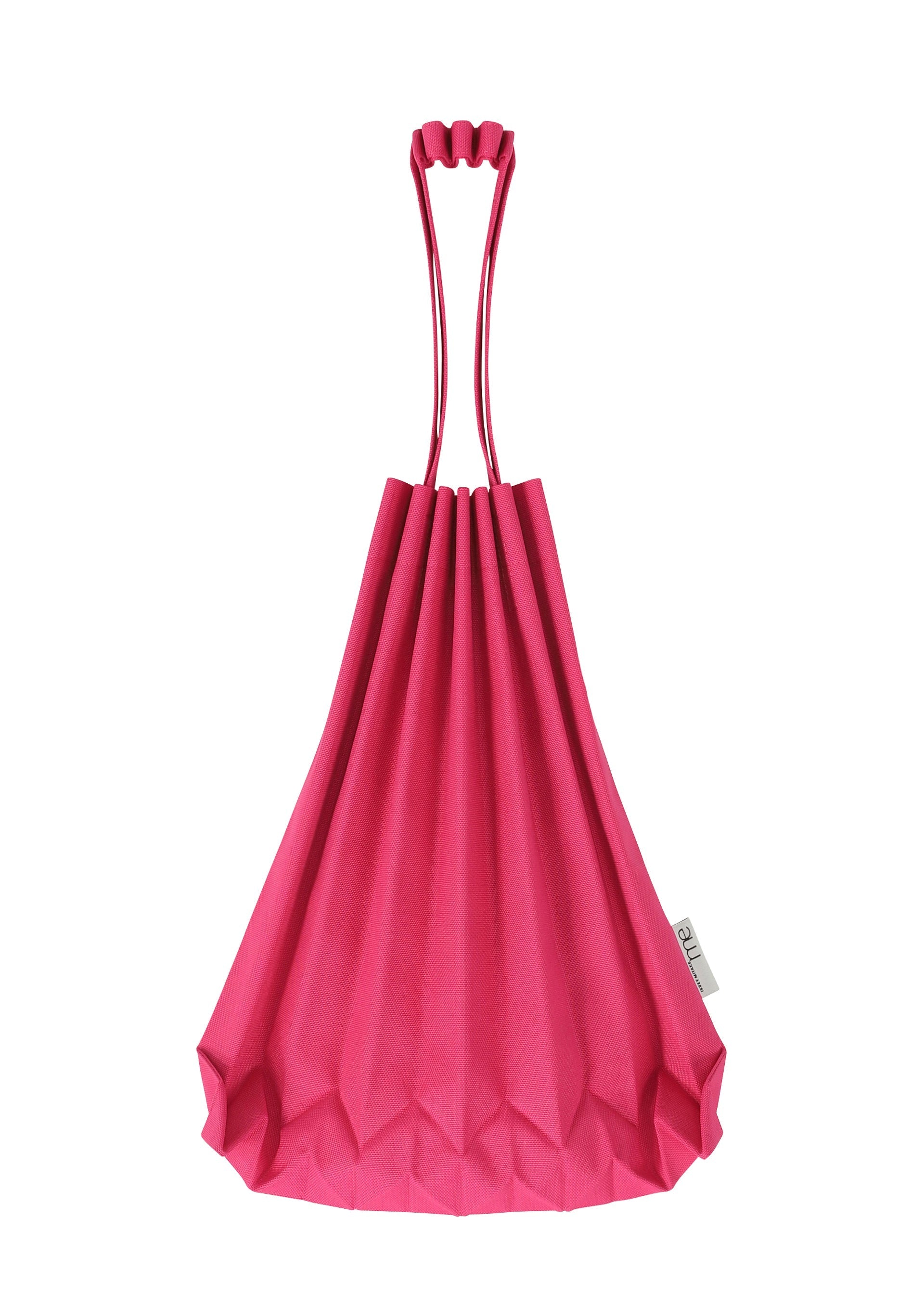 Zoomed view The TRUNK PLEATS BAG 12 by me ISSEY MIYAKE is a bright pink mini tote with pleats, two looped handles, a geometric origami-inspired design, and a small white fabric tag for a stylish finish.