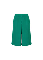 The SWEATS PLEATS by me ISSEY MIYAKE are green, knee-length shorts with a ribbed vertical texture, elastic waistband, and relaxed fit, shown on a white background. - PEACOCK GREEN （no.64）