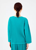 A person with dark hair in a low ponytail wears the teal SWEATS PLEATS set by me ISSEY MIYAKE—long-sleeved top and matching bottoms—standing with their back to the camera against a plain, light background.