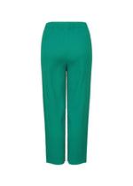 The SWING PLEATS pants by me ISSEY MIYAKE are green, ankle-length, pleated knit pants with an elastic waistband, made from stretchy soft yarn. They feature a straight-leg cut and are shown against a white background.