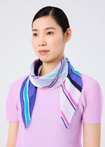 A woman with straight dark hair wears a light purple top and the SHIRT STRIPE PLEATS STOLE by me ISSEY MIYAKE—featuring blue, purple, pink, and white stripes—draped around her neck, set against a plain light background.