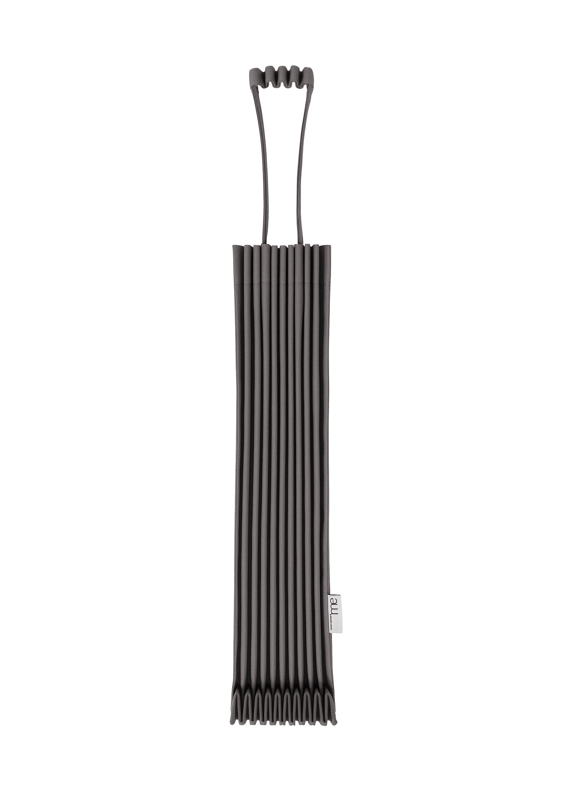 Zoomed view The TRUNK PLEATS BAG 12 by me ISSEY MIYAKE, shown against a white background, features black ribbed silicone, a distinctive top handle, and a small fabric tag on the side.