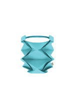 The GEOMETRIC PLEATS BAG by me ISSEY MIYAKE, in turquoise with origami-inspired angular folds and a top handle, is shown against a white background. - LIGHT BLUE （no.70）