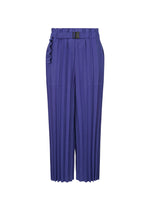 The COLOR PLEATS BOTTOM by me ISSEY MIYAKE are high-waisted, wide-leg pleated pants in vibrant purple with a matching belt and black buckle, featuring a paperbag waistband and ankle length for a bold, versatile look. - COBALT BLUE （no.74）