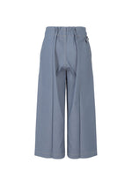 The FLAT DENIM wide-leg, high-waisted light blue pants by me ISSEY MIYAKE are made from recycled polyester denim with a gathered waistband and loose fit, shown against a plain white background.