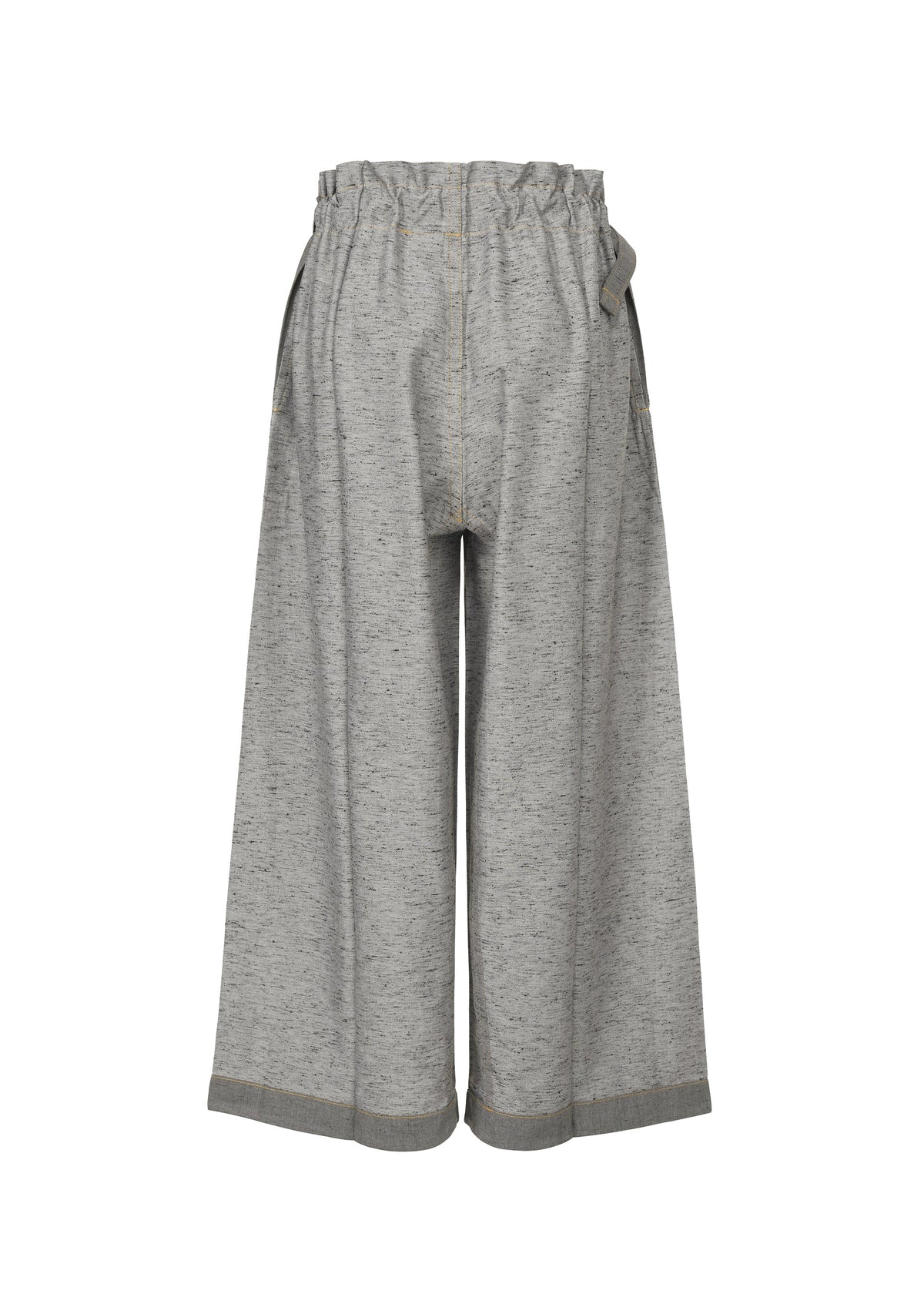 The me ISSEY MIYAKE REmeTEX NEP DENIM pants feature wide legs, an elastic ruffled waistband, visible seams, and a heathered look. Made from recycled polyester with a relaxed fit and subtly flared silhouette. view 3 of 6