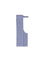 The FLAT BOTTOM apron by me ISSEY MIYAKE is a folded light blue melange-look fabric with a neck strap and side waist ties, shown against a plain white background.