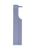 The FLAT BOTTOM apron by me ISSEY MIYAKE, made from soft cationic yarn for a flowy feel, features a neatly folded light blue design with a neck strap, shown against a white background.