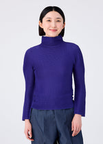 A person with straight dark hair smiles softly against a plain light background, wearing the STRETCH PLEATS 1 royal blue long-sleeved high-neck top and dark blue pants by me ISSEY MIYAKE.