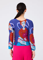 A person with long dark hair in a low ponytail is seen from behind, wearing the me ISSEY MIYAKE "CAT" blue stretch pleats top with an artistic woman-and-cat illustration, paired with bright pink pleated pants.