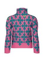 The SUIT top by me ISSEY MIYAKE features a high neck, long sleeves, pink base, and playful teal four-leaf clover playing card motifs. Stretch pleats design shown from the back against a white background.