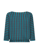 The MAGIC STRIPE top by me ISSEY MIYAKE features bold black and teal vertical stripes on the front and horizontal stripes on the sleeves, set against a white background.