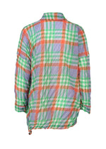 The CHECK WHIPPED PLEATS SHIRT by me ISSEY MIYAKE is a sheer, long-sleeved top with a crinkled texture, crafted from yarn-dyed checkered fabric in orange, green, white, and blue. Shown from the back.