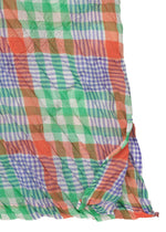 The CHECK WHIPPED PLEATS SHIRT by me ISSEY MIYAKE features a lightweight, semi-transparent, crumpled yarn-dyed check fabric with a colorful plaid in green, orange, blue, and white—perfect for a sheer long-sleeved look.
