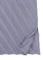 A close-up of the ANGLE PLEATS SHIRT by me ISSEY MIYAKE, featuring lightweight pleated purple fabric and a slit hem.