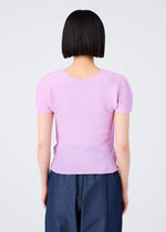 A person with straight, chin-length black hair faces away from the camera, wearing a short-sleeved, light purple STRETCH PLEATS 5 top by me ISSEY MIYAKE and dark blue pants against a plain light background.