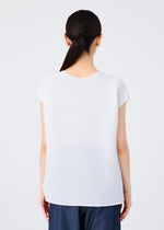 A person with long dark hair in a low ponytail is seen from behind, wearing the me ISSEY MIYAKE SQUARE STRETCH PLEATS top and blue pants against a plain white background.