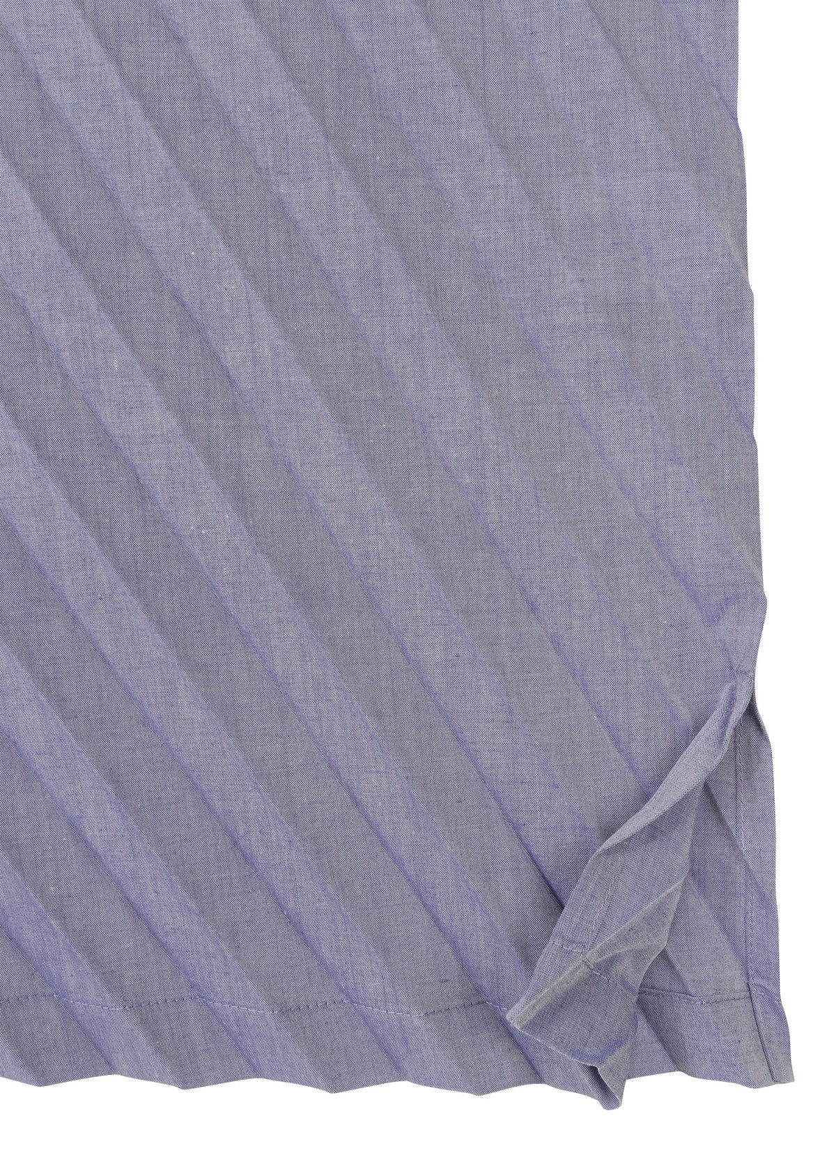 A close-up of the ANGLE PLEATS SHIRT by me ISSEY MIYAKE shows its light purple, lightweight fabric with diagonal stripes, a neatly hemmed edge, and a small fold in the bottom right corner. view 5 of 9