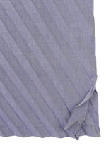 A close-up of the ANGLE PLEATS SHIRT by me ISSEY MIYAKE shows its light purple, lightweight fabric with diagonal stripes, a neatly hemmed edge, and a small fold in the bottom right corner.