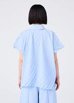 A person with short black hair is seen from behind, wearing the me ISSEY MIYAKE ANGLE PLEATS SHIRT in light blue with matching wide-legged pleated pants, set against a plain white background.