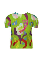 The FLOWER DOME top by me ISSEY MIYAKE is a round-neck, short-sleeve style featuring a vibrant abstract floral and geometric pattern in green, red, purple, blue, yellow, and white on the front.