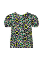 The KALEIDOSCOPE short-sleeved blouse by me ISSEY MIYAKE features a round neckline and a vibrant geometric and floral pattern in yellow, green, purple, black, and beige. - BLACK-HUED （no.18）