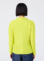 A person with a straight, chin-length bob is shown from behind wearing me ISSEY MIYAKE’s KNIT STRETCH PLEATS 1 top in bright yellow with long sleeves and dark blue pants, set against a plain light background.