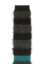 The TAIL SOCKS by me ISSEY MIYAKE feature fuzzy, fluffy texture with black, dark gray, and teal horizontal stripes. Soft and cozy with a shaggy fringe look, these socks are shown upright with the top cuff visible.