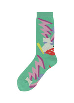 The SURPRISE BOX SOCKS by me ISSEY MIYAKE are bold green novelty socks featuring abstract zigzag patterns in pink, purple, yellow, white, and red—ideal for fans of colorful, unique geometric designs. - GREEN-HUED （no.69）