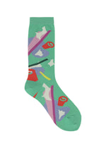 The SURPRISE BOX SOCKS by me ISSEY MIYAKE are green novelty socks featuring vibrant abstract patterns in red, purple, white, yellow, and pink for a playful touch.