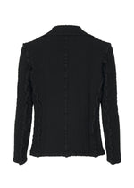 The CAULIFLOWER JACKET by me ISSEY MIYAKE is shown from the back in black textured fabric, featuring visible seam details and a slightly tailored long-sleeve fit for a modern look.