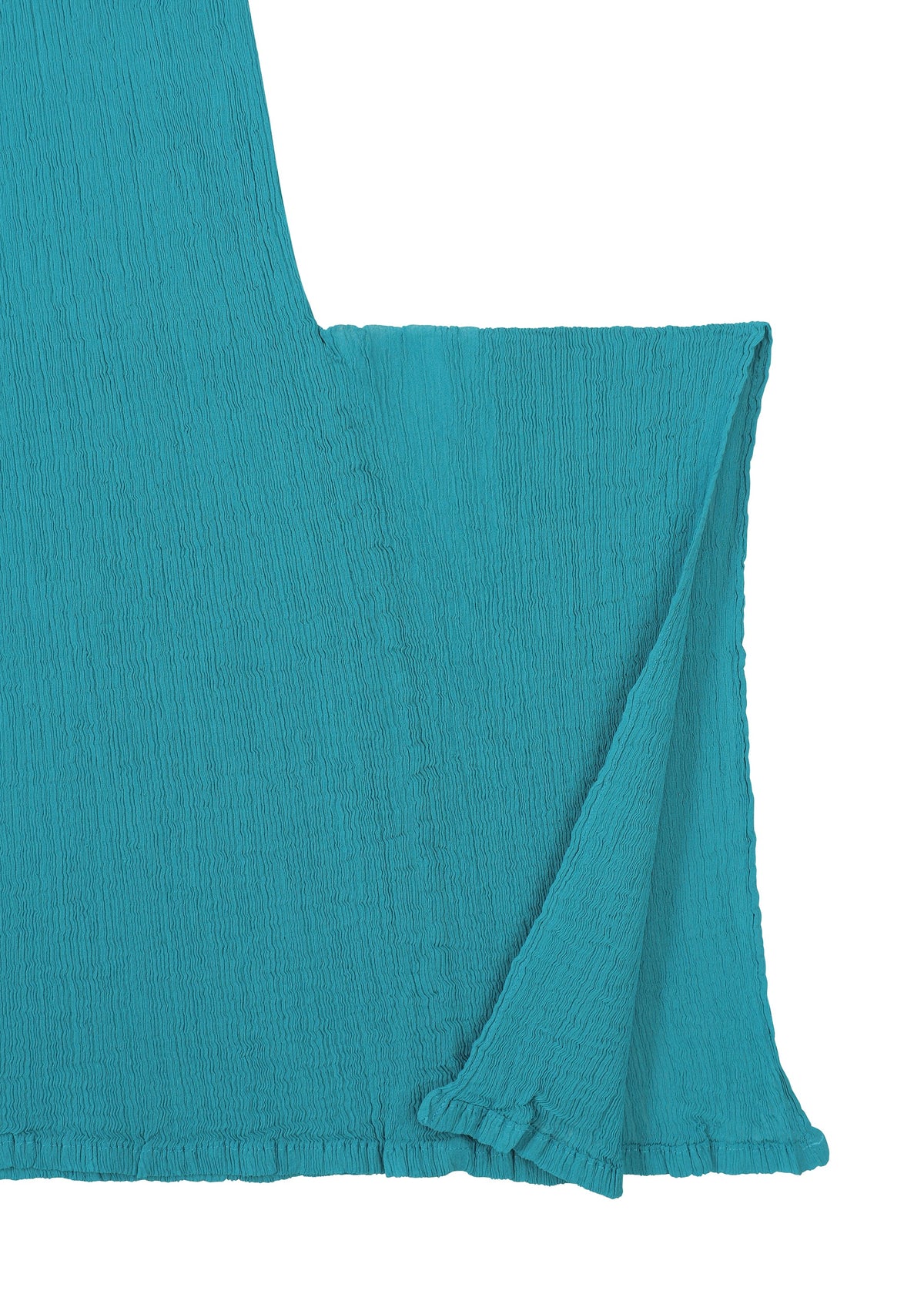A close-up of the FLAT SEE-THROUGH CREPE by me ISSEY MIYAKE in teal, highlighting its textured, crinkled surface and clean edges with a sleeve or draped panel extending right, set against a white background. view 6 of 8