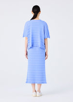 A woman with dark hair in a low ponytail, seen from behind, wears the me ISSEY MIYAKE RIPPLE SEE-THROUGH CREPE light blue top and matching midi skirt with textured stripes, paired with white shoes, against a plain white background.