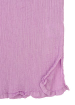 Close-up of the SEE-THROUGH CREPE COLOR top by me ISSEY MIYAKE in textured light purple, featuring garment-dyed crinkled fabric, a round neck, short sleeves, a ruffled hem, and a small side slit for added tactile appeal.