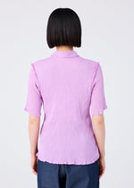 A person with straight, chin-length black hair is seen from behind, wearing the me ISSEY MIYAKE SEE-THROUGH CREPE COLOR light purple collared short-sleeved top and dark blue pants against a plain light background.