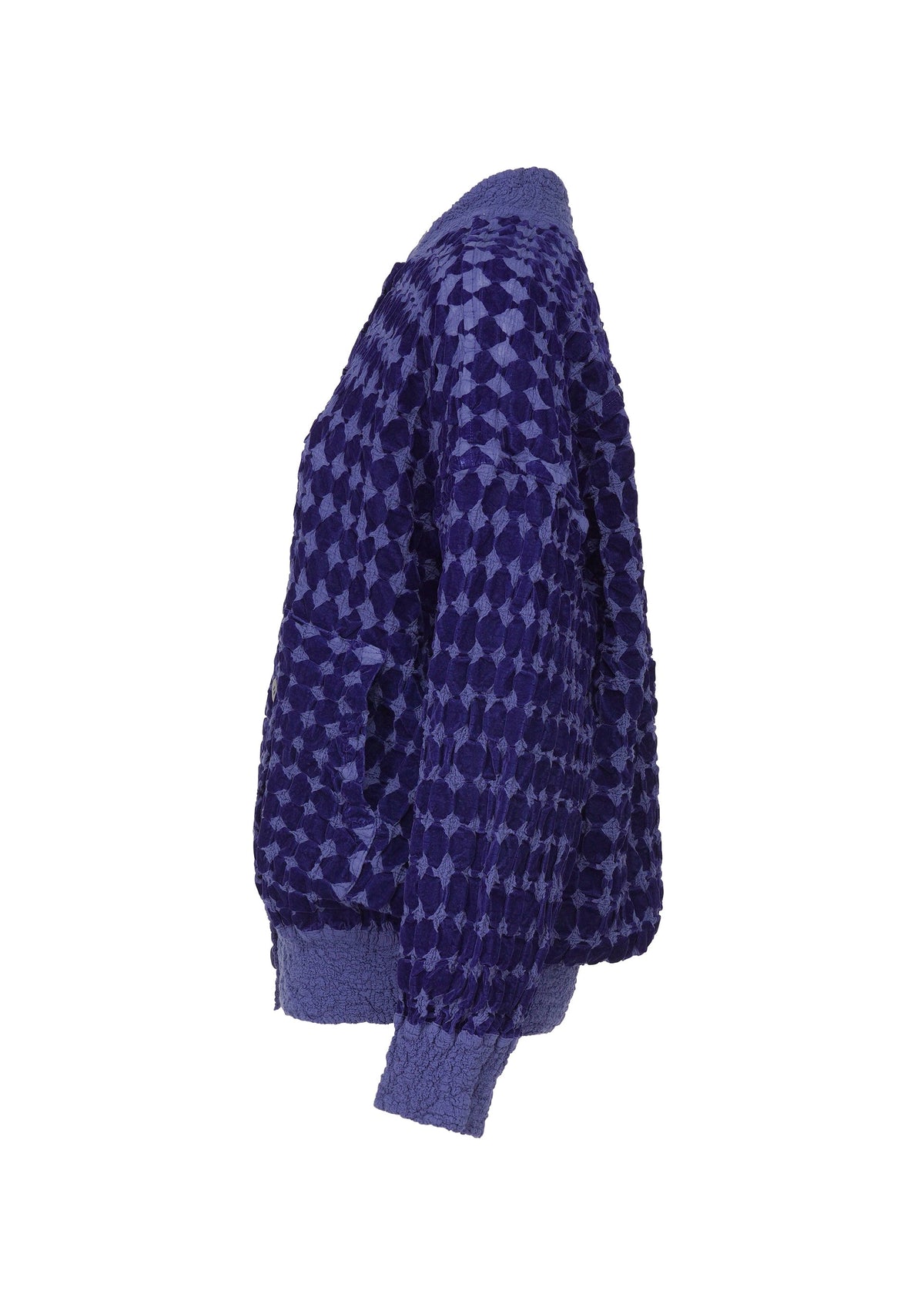 The DIAMOND FLOCKY CAULIFLOWER cardigan by me ISSEY MIYAKE features deep blue, diamond-patterned flock printing, ribbed cuffs, hem and collar, and is crafted from unique CAULIFLOWER material. Shown side view on a white background. view 4 of 7