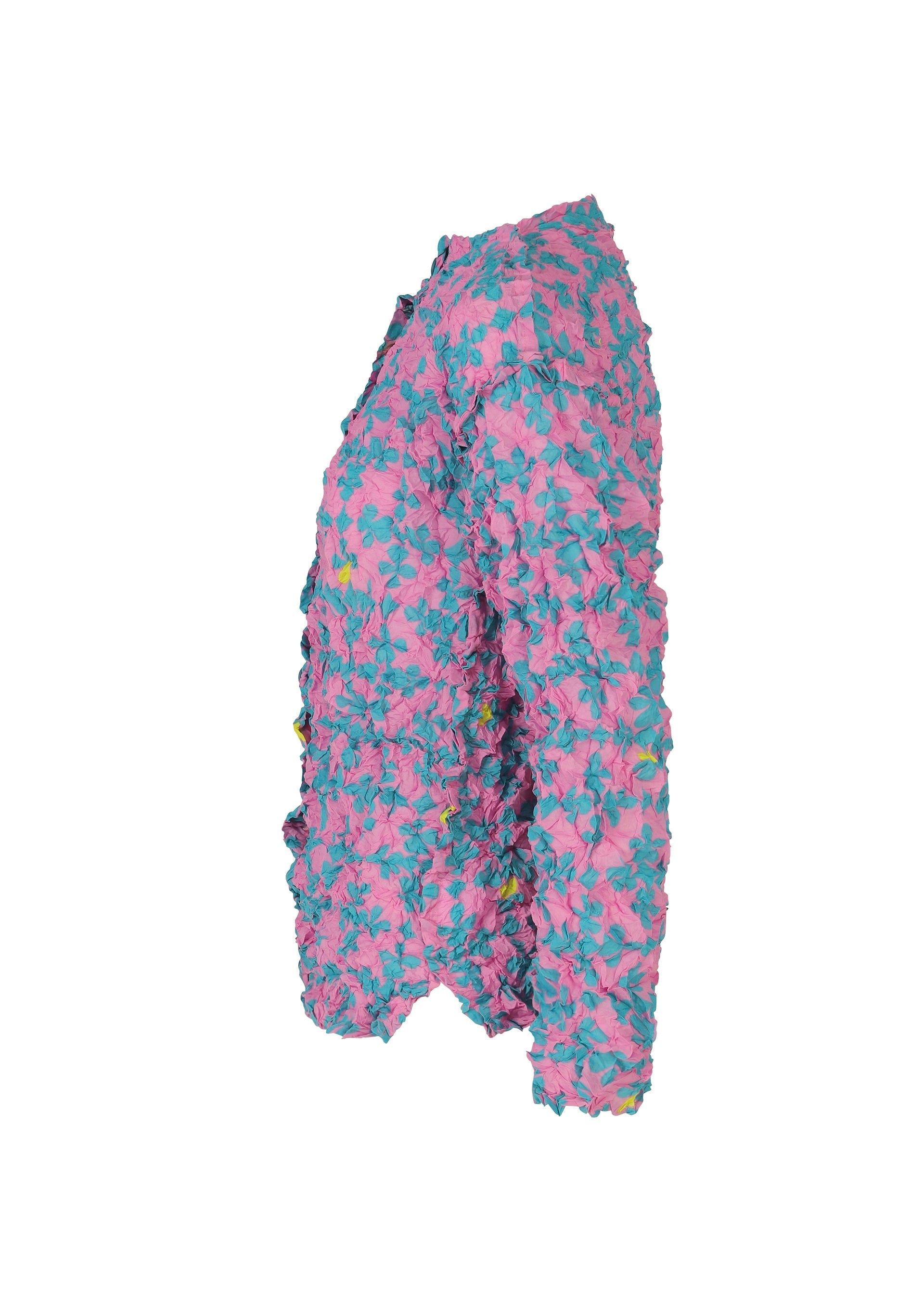 Zoomed view Side view of the SUIT MERINGUE TOP by me ISSEY MIYAKE—a textured, long-sleeved cardigan with a crushed pleat finish, featuring a pink base adorned with blue floral patterns and vibrant, eye-catching details.