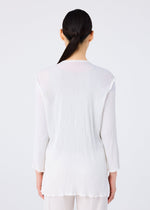 A woman with long dark hair in a low ponytail stands with her back to the camera, wearing the SEE-THROUGH CREPE COLOR top and matching pants by me ISSEY MIYAKE, against a plain light background.