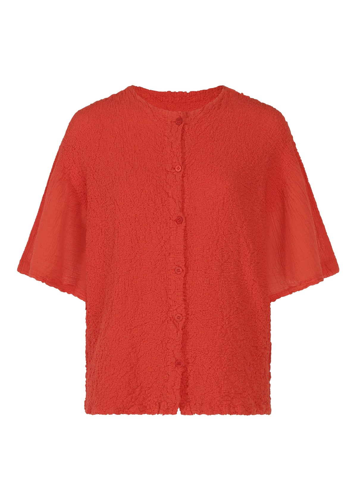 The SHEER CAULIFLOWER by me ISSEY MIYAKE is a bright red, textured short-sleeve button-up blouse with a round neckline and relaxed fit, inspired by the look of a cotton cardigan. view 2 of 7