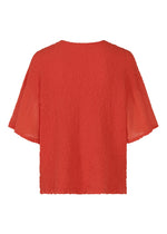SHEER CAULIFLOWER by me ISSEY MIYAKE is a loose-fit, red cotton cardigan with short sleeves. Shown from the back, its textured fabric is slightly sheer on the sleeves and features a subtle crinkled pattern throughout.