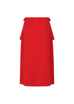 The FLAT JERSEY skirt by me ISSEY MIYAKE is a vibrant red, knee-length cotton-blend skirt featuring an elastic waistband and minimalistic, straight silhouette—no visible patterns or pockets, making it a versatile choice for any occasion.