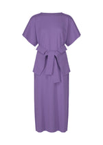 The FLAT JERSEY dress by me ISSEY MIYAKE is a knee-length, short-sleeve lavender cotton-blend piece with a round neckline and wide fabric belt. Its garment-dyed finish gives it a simple, elegant, and modern look. - VIOLET （no.82）