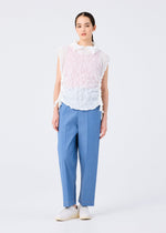 A woman with straight dark hair pulled back wears the KALEIDOSCOPE LACE MERINGUE sleeveless top by me ISSEY MIYAKE in white and pale pink, paired with blue high-waisted trousers and white shoes against a plain white background.