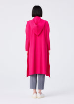 Seen from behind, a person with short black hair wears the FLARE PLEATS vest by me ISSEY MIYAKE in bright pink, paired with gray pleated pants and white slip-on shoes, standing against a plain white background.