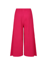 FLARE PLEATS by me ISSEY MIYAKE: bright pink wide-leg culottes with a flared silhouette, elastic waistband, and fine knit pleats, shown against a white background.