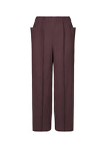 The FINE KNIT PLEATS COLOR 1 pants by me ISSEY MIYAKE feature a wide-leg, high-waisted fit in deep brown with pinstripes, elastic waistband, and side pockets. Made from lightweight fabric and shown on a plain white background. - BORDEAUX （no.84）