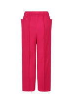 The FINE KNIT PLEATS COLOR 1 pants by me ISSEY MIYAKE feature a bright pink hue, straight-leg cut, subtle vertical texture, fine knit pleats, and an elastic waistband. Shown on a plain white background; lightweight for all-day comfort.