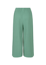 The FINE KNIT PLEATS BOTTOM 1 by me ISSEY MIYAKE are wide-leg, light green pants with fine knit pleats and an elastic waistband, shown against a white background.